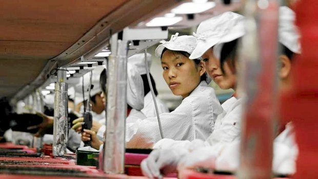 Workers are seen inside a Foxconn factory in Longhua, China in 2010. Foxconn, a major supplier of Apple is said to be improving workplace conditions.