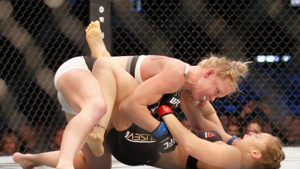Challenger Holly Holm knocks down champ Ronda Rousey in UFC 193 at Etihad Stadium.