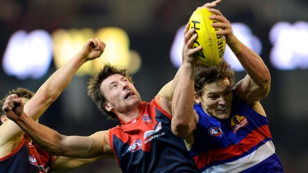 Vice-like grip: Bulldogs ruckman Will Minson takes a strong mark in front of Jack Fitzpatrick.