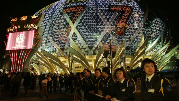 Security guards stand outside the Grand Lisboa Casino in Macau.
