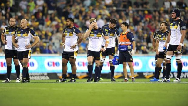 ACT Brumbies players react to their loss against the Queensland Reds at Canberra Stadium.