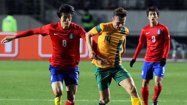 Australia's James Holland makes a break with Koh Myung-jin of South Korea in pursuit.