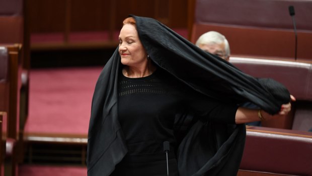 Senator Pauline Hanson takes off a burqa during Senate Question Time.