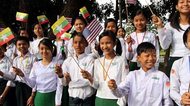 Waiting &#8230; students at the airport wave US and Burmese flags.