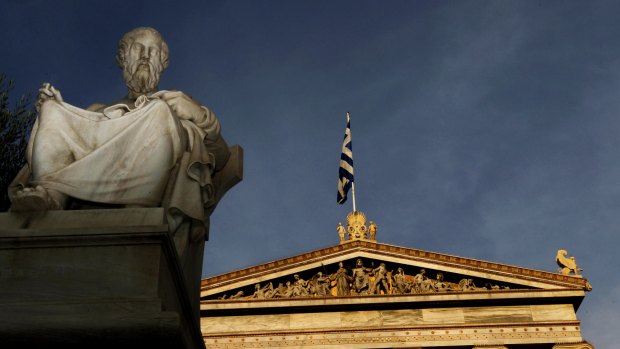 In this photo taken Friday, Oct. 21, 2011, a marble statues of ancient Greek philosopher Plato is seen on a plinth in front of the Athens Academy, as the Greek flag flies. More than 200 international philosophers braved strikes and protests to come to Greece this month to join a forum and debate matters of the mind. Greece's illustrious ancient thinkers built the foundations of Western scholarship, and their philosophy stands as an unquantifiable source of national wealth even during a financial crisis. (AP Photo/Petros Giannakouris)