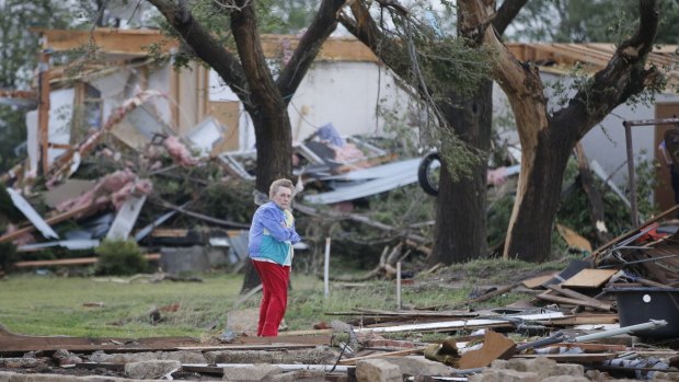 Charmaine Foraker looks out over the farmhouse she grew up in at her family's farmstead near Bentley, Kansas, which was destroyed by a tornado on Wednesday.