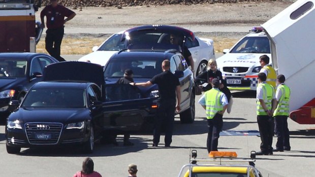 A band member of the Rolling Stones, reportedly Mick Jagger, walks from his car to the aircraft to board at Perth international airport on March 20, 2014 in Perth, Australia.