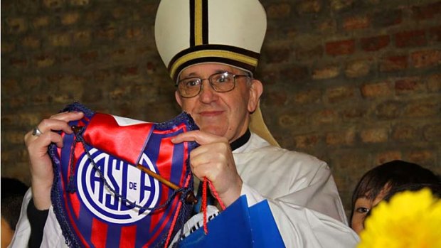 Argentine Cardinal Jorge Bergoglio poses with a jersey from the San Lorenzo soccer club.