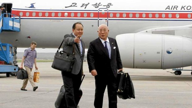 Rare visit: Isao Iijima, right,  adviser to Japan's Cabinet, arrives at Pyongyang airport on Tuesday.