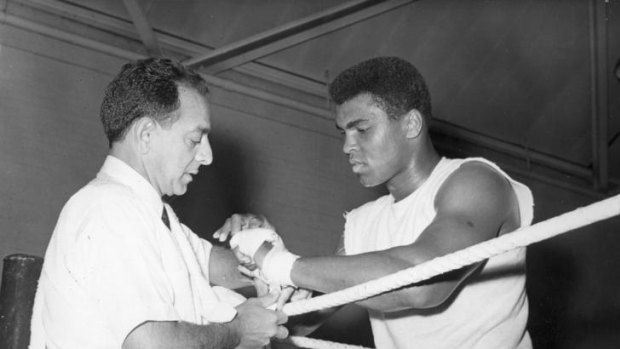 Muhammad Ali has his hands bandaged by his manager Angelo Dundee in 1963