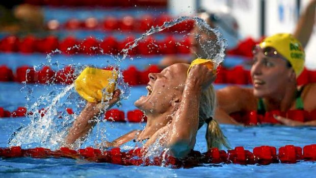 Sarah Sjostrom of Sweden celebrates after winning the 100m butterfly final ahead of Coutts (R).