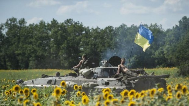 Ukrainian troops rest on an APC in eastern Ukraine.