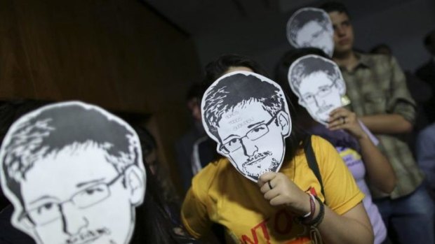 Behind the mask: Edward Snowden's revelations forced the issue of court authorisation for surveillance into the open.