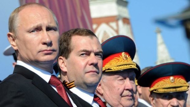 Russian President Vladimir Putin, left, and Prime Minister Dmitry Medvedev attend a Victory Day military parade in Red Square.