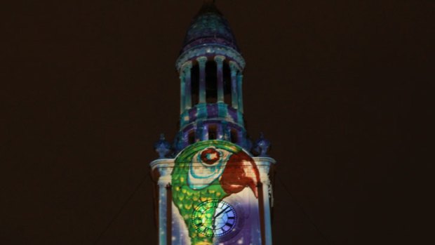 Cor, it's Mary Poppins ... London rooftops, chimney sweeps and a very special umbrella are projected onto Sydney Town Hall.