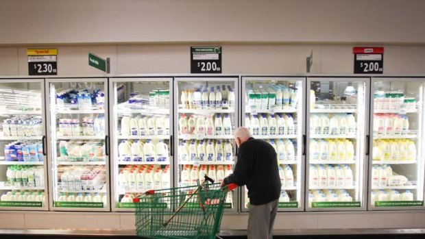 A shopper browses the milk section at a Woolworths.