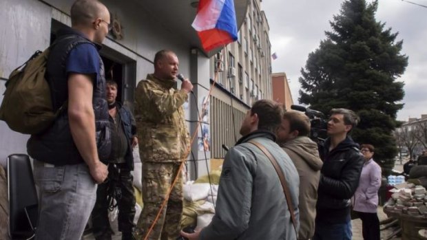A pro-Russian activist, calling himself Vasiliy, speaks to other protesters in Luhansk.