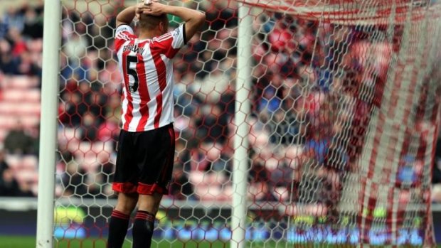 Sunderland's Wes Brown stands dejected after scoring a own goal against Everton.