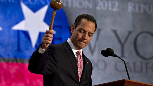 Reince Priebus, chairman of the Republican National Committee, raises a gavel as he calls the Republican National Convention to order in Tampa, Florida.