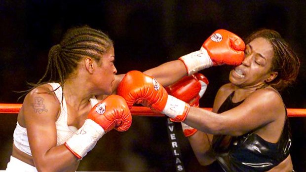 Laila Ali, (left) the 23-year-old daughter of boxing legend Muhammad Ali, lands a left jab to the head of 39-year-old Jacqui Frazier, the daughter of boxer Joe Frazier during the seventh round of their bout at Turning Stone Casino in Verona, New York, on June 8, 2001.