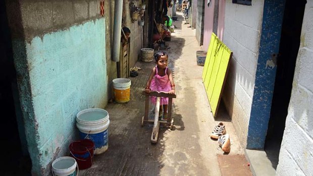 Long wait: A Tamil refugee plays between rows of houses in a Sri Lankan refugee camp at Thuraimangalam in Perambalur district, about 250 kilometres from Chennai, India.