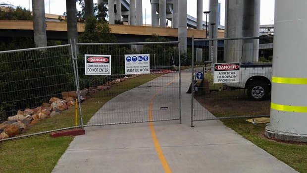 Signs on fences blocking the path have warned of asbestos being removed.
