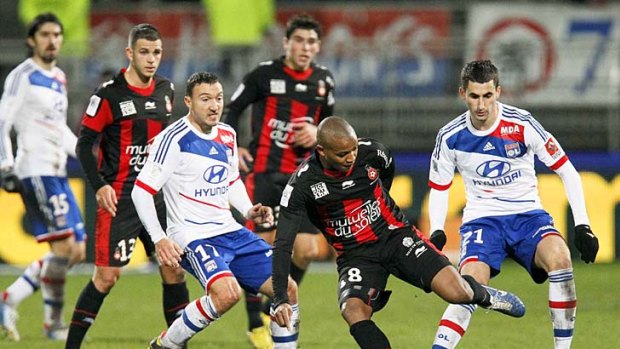 Olympique Lyon's Steed Malbranque (third left) challenges Mahamane Traore (second right) of Nice during their Ligue 1 match at the Gerland stadium in Lyon.
