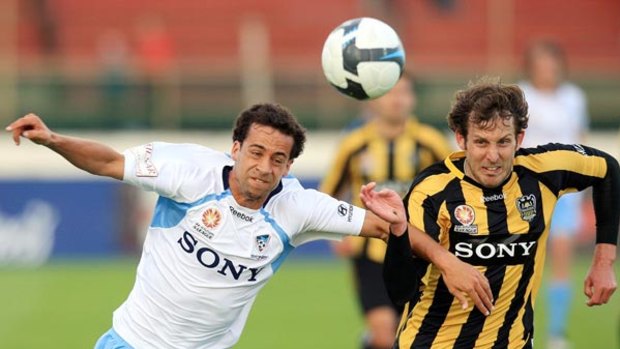 Hard fought win . . . Sydney's Alex Brosque goes into battle for the ball with Jonathan McKain of the Phoenix.