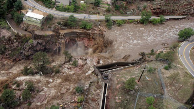 This aerial photo shows a  raging waterfall destroying a bridge along Highway 34 toward Estes Park, Colorado.
