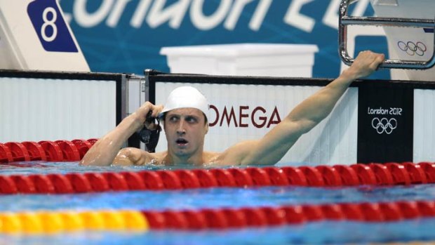 Nick D'Arcy turns to look at his time in his 200m butterfly semi-final at the London Olympics. He failed to make the final.