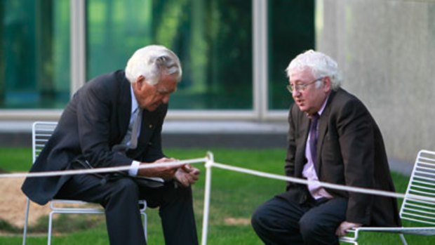 So last century ... cigar smoking Bob Hawke chats with Bill Kelty in a garden at Parliament House.