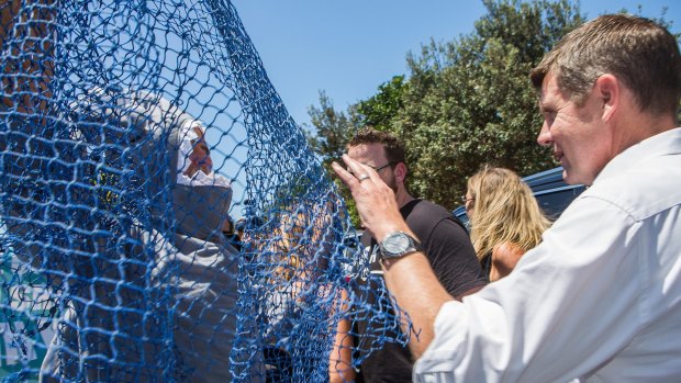 A protester attempts to net Premier Mike Baird in Ballina after the instalment of the first shark net on the North Coast.