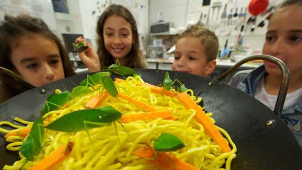 Maria Catsicakis 9 , Allegra Gold 9 , Louie Peronne 6 and Natasha Perrone 8 contemplate a noodle dish served with insects at the Melbourne Museum yesterday.