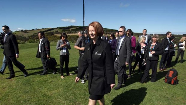 Rushing home ... Gillard leaves a photo shoot at the Pacific Conference in New Zealand.