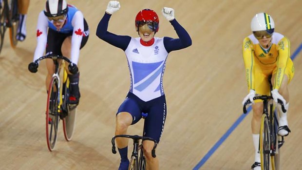 Victoria Pendleton celebrates as Anna Meares, right, trails in behind.