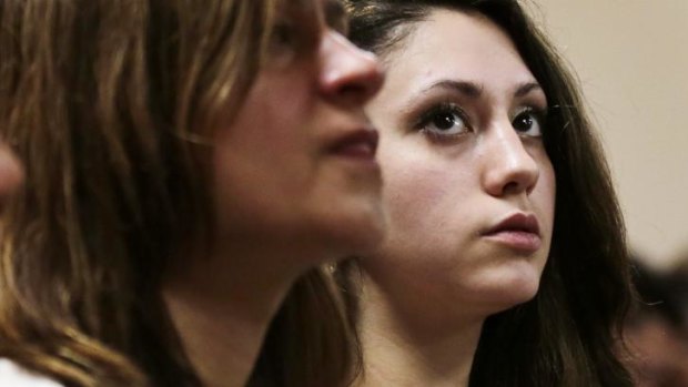 Abigail Hernandez, right, sits with family and friends as she listens to her mother Zenya Hernandez, speak to lawyer.