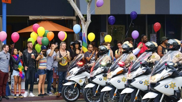 Los Angeles County Sheriff's department motorcycle deputies ride along a street in West Hollywood, California, during the Gay Pride Parade.
