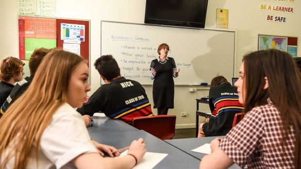 Williamstown High School VCAL students and teacher Anne Goller do the maths on gambling risks.