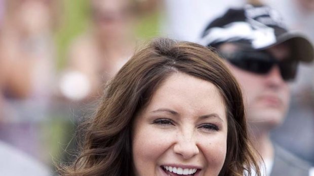 Bristol Palin, daughter of Sarah Palin,  smiles before taking part in the Rolling Thunder motorcycle ride.