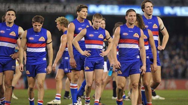 A familiar sight: The Western Bulldogs trudge back to the dressing rooms after being defeated by Carlton on Saturday.
