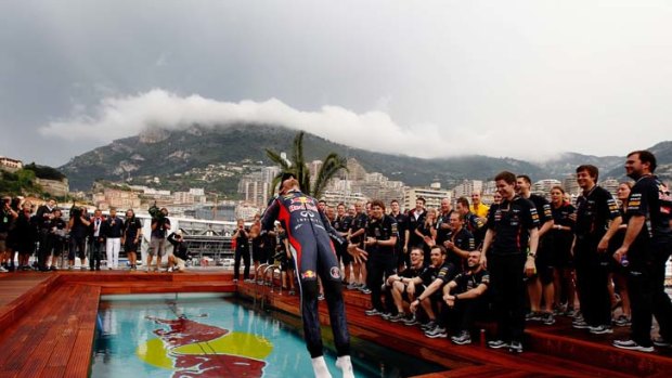 Historic win ... Webber decided to celebrate by backflipping into the Red Bull swimming pool.
