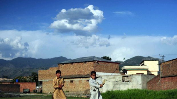 Pakistani youth play cricket near the final hideout of slain Al-Qaeda chief Osama Bin Laden in Abbottabad, Pakistan in 2011.  