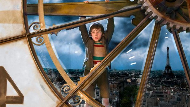 Hanging by a hand: Hugo (Asa Butterfield) gets himself in a tricky situation in Martin Scorsese's masterful 3D film <i>Hugo</i>.