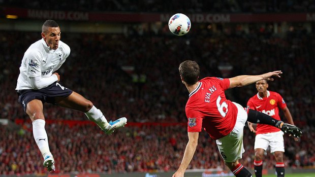 High-flyers: Tottenham's Jake Livermore leaps to block a kick by Manchester United's Jonny Evans.
