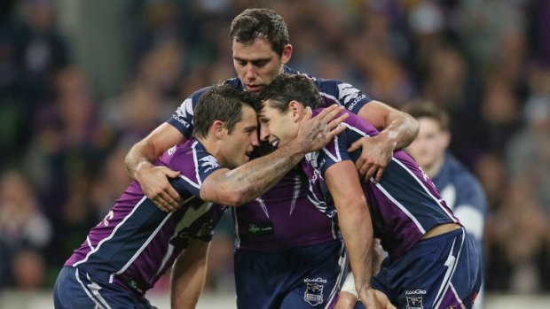 On a high: The Storm's Cameron Smith, Cooper Cronk and Billy Slater celebrate a try in their win against the Manly Sea Eagles.