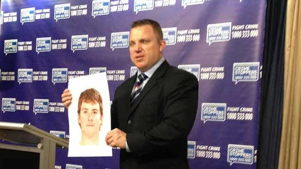 Police with a picture of the missing teenager.
