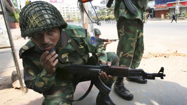 Bangladeshi army troops face off against rebellious border guards in Dhaka.