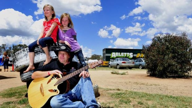 Guitarist Ian Wholohan of Jerrabomberra with his daughters, Samantha,7, and Rachel, 9.