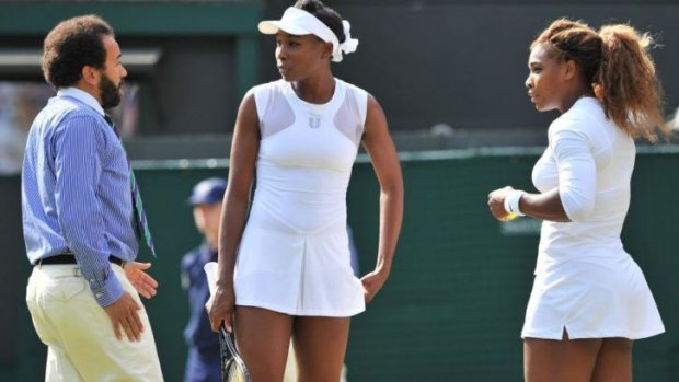 The match umpire talks with Williams sisters.