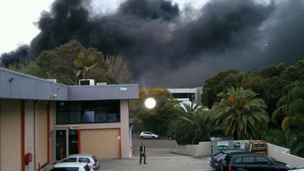 Smoke rises in Mona Vale after a fatal crash involving a fuel tanker.